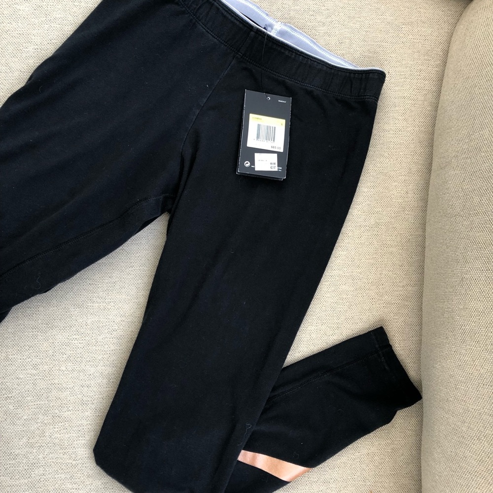 NWT bronze Nike sign leggings